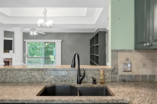 a view of a kitchen sink a faucet and a fireplace