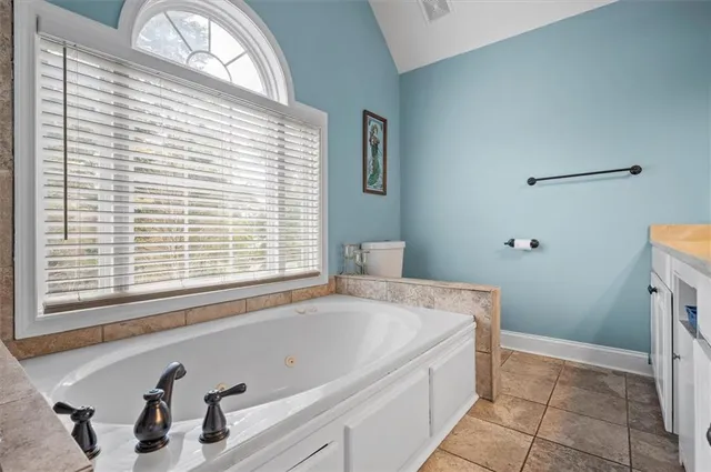 a bathroom with a bathtub and a window