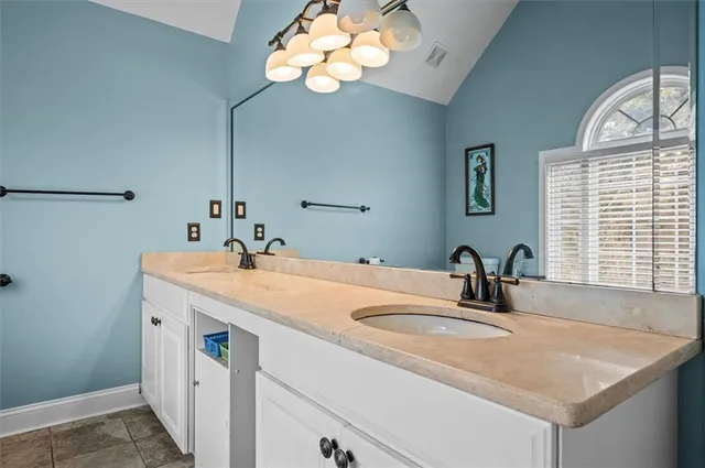 a bathroom with a sink a vanity and a mirror