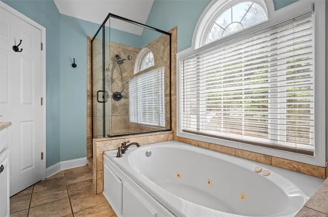 a bathroom with a bathtub and a shower