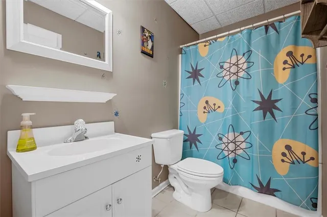 a bathroom with a sink mirror vanity and toilet