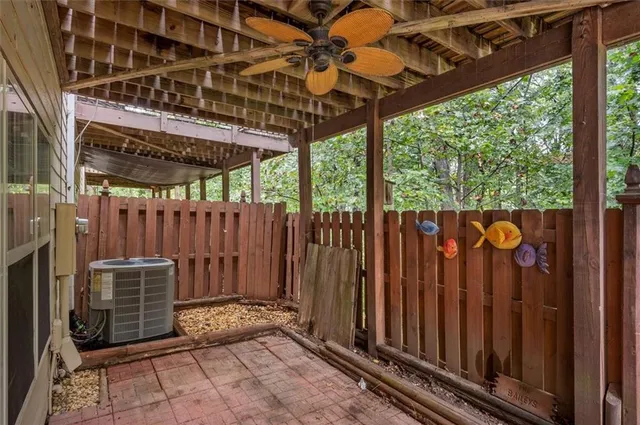 a view of a backyard with wooden fence