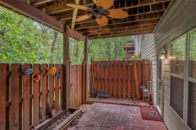 a view of a backyard with wooden fence