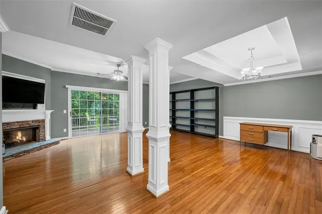 a view of empty room with wooden floor and fireplace