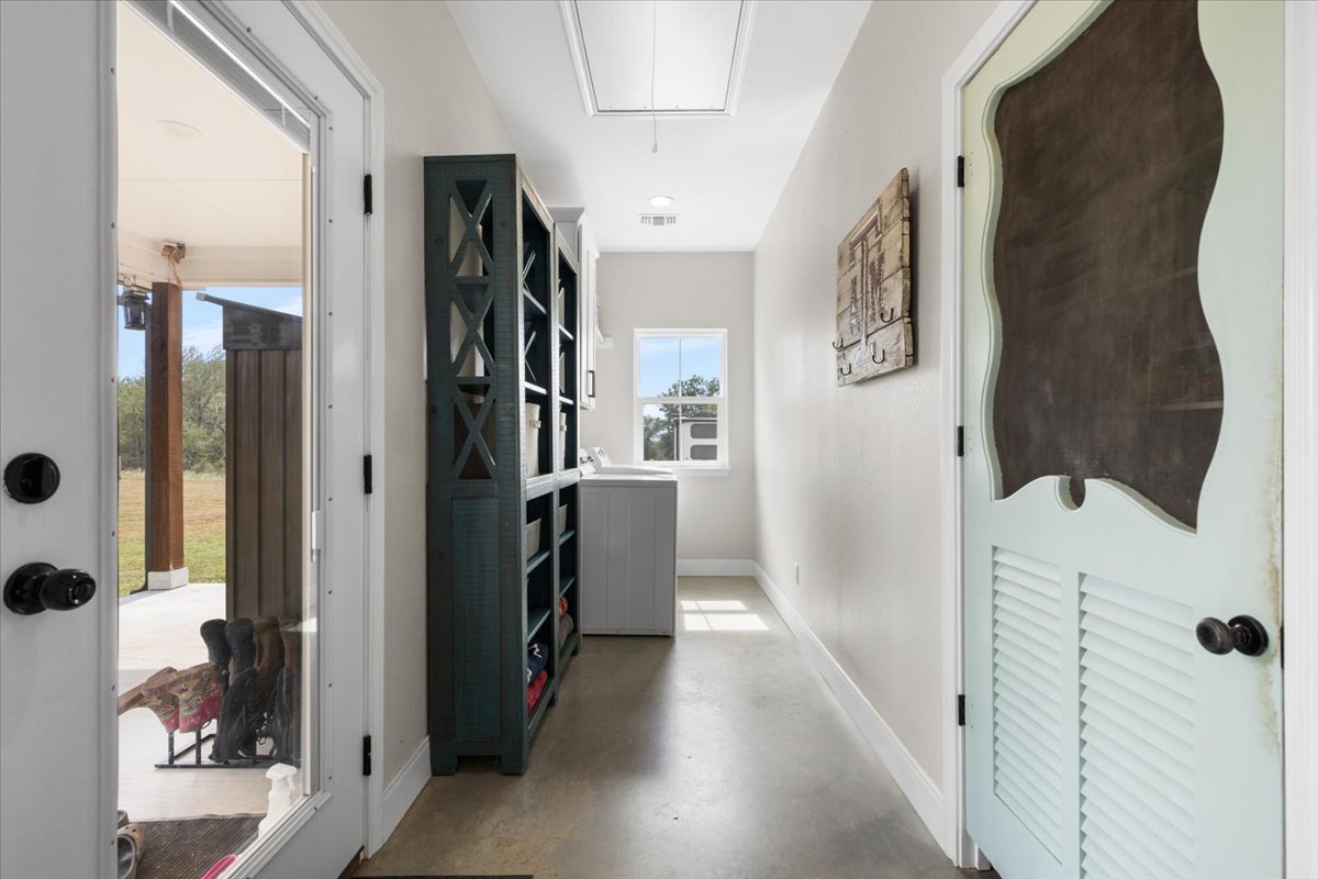 3389 Sparta Field Road Waelder, TX 78959 - Photo 21 of 40 Corridor featuring attic access and concrete flooring