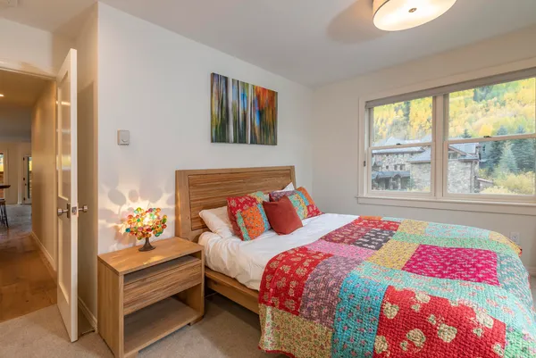 a bedroom with a bed and a large window