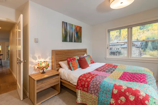 a bedroom with a bed and a large window