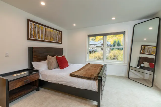 a bedroom with a bed and a large window