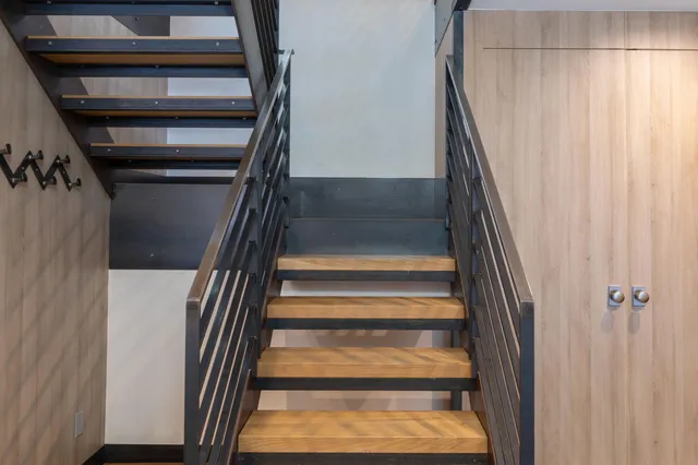 a view of staircase with white walls and a window