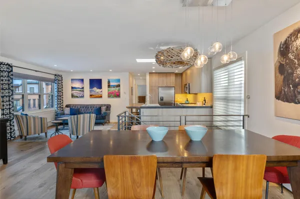 a view of a dining room with furniture and chandelier