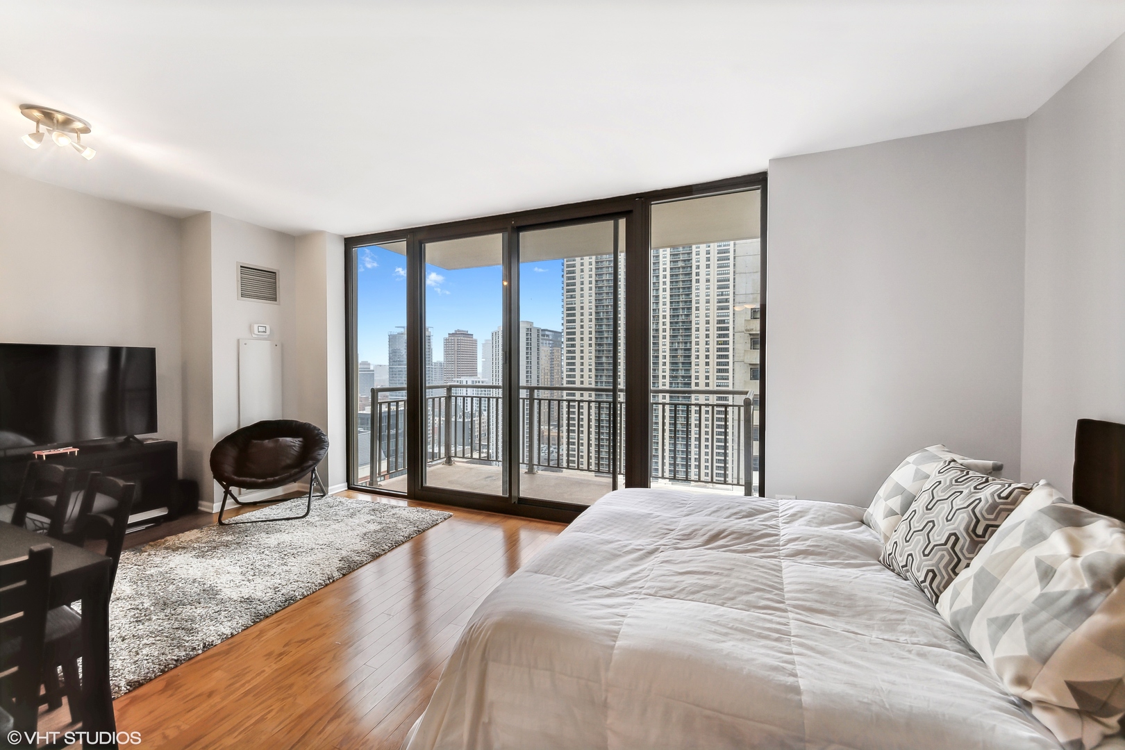 630 North State Street, Unit 2401 Chicago, IL 60654 - Photo 4 of 14 a bedroom with a bed and a large window