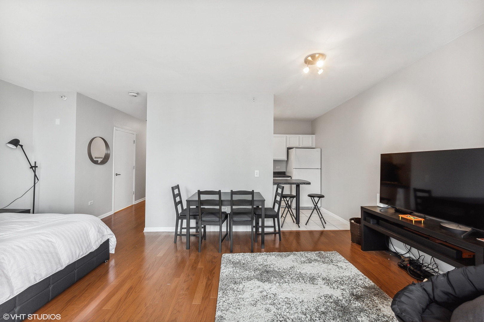 630 North State Street, Unit 2401 Chicago, IL 60654 - Photo 6 of 14 a living room with furniture and a flat screen tv