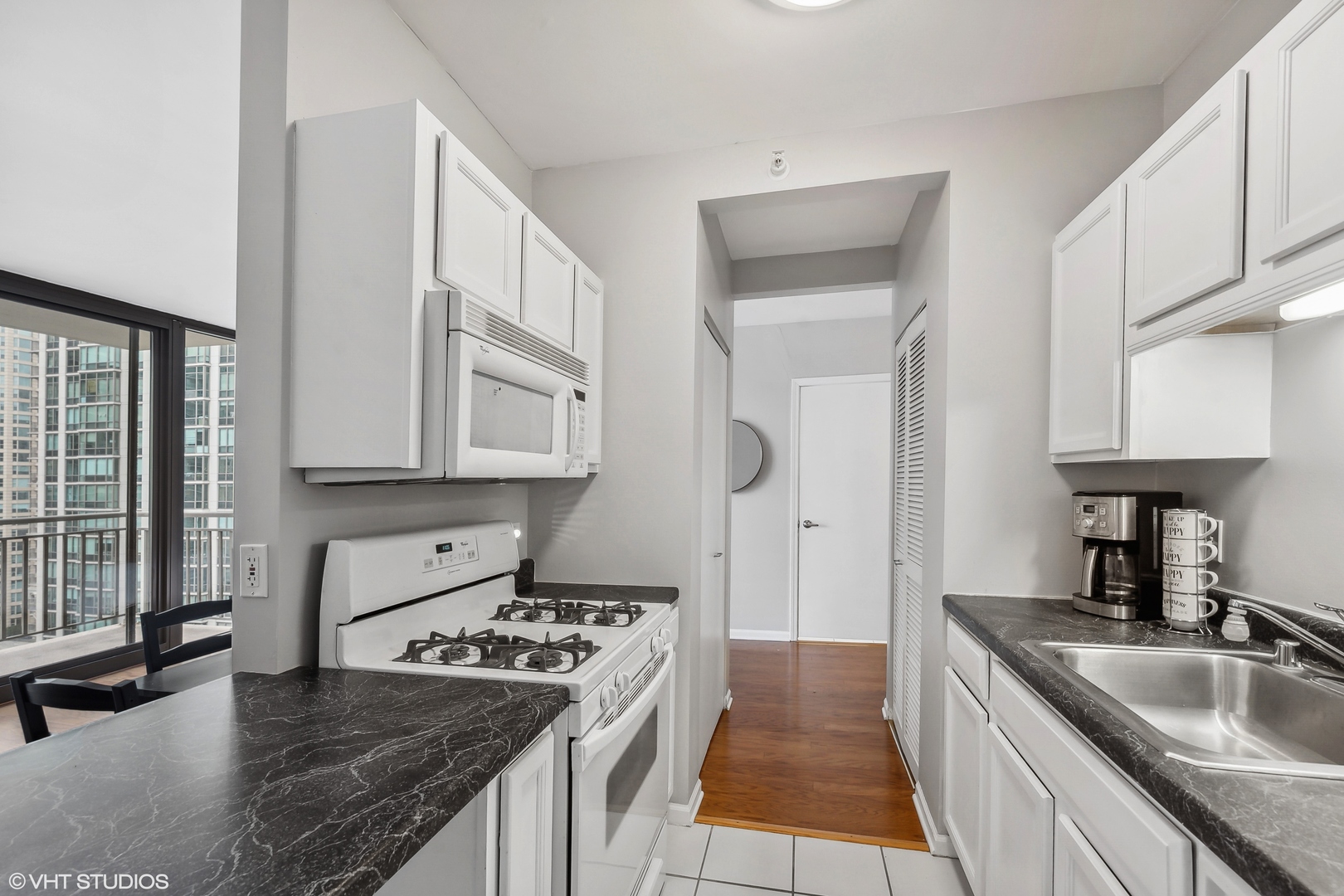 630 North State Street, Unit 2401 Chicago, IL 60654 - Photo 7 of 14 a kitchen with stainless steel appliances granite countertop a sink stove and cabinets