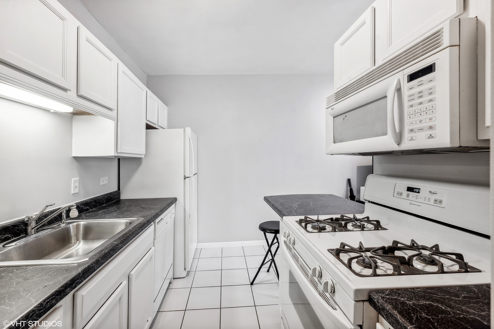 630 North State Street, Unit 2401 Chicago, IL 60654 - Photo 8 of 14 a kitchen with stainless steel appliances a stove a sink and a refrigerator