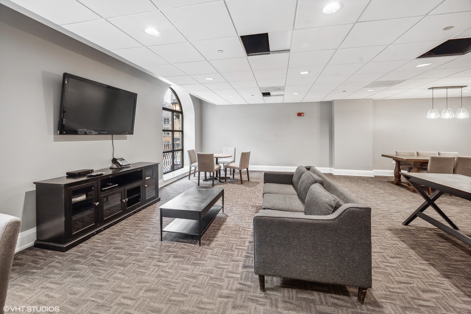 630 North State Street, Unit 2401 Chicago, IL 60654 - Photo 10 of 14 a living room with furniture and a flat screen tv
