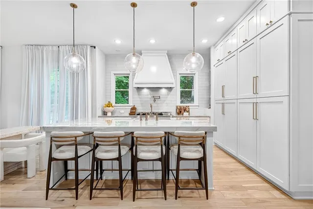 a kitchen with a stove a table and chairs in it
