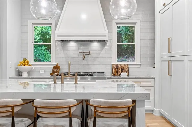 a kitchen with stainless steel appliances granite countertop a sink and a stove