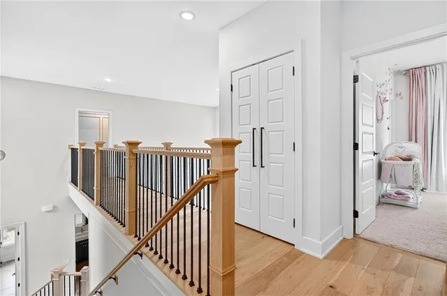a bedroom with a large bed and a flat tv screen on dresser