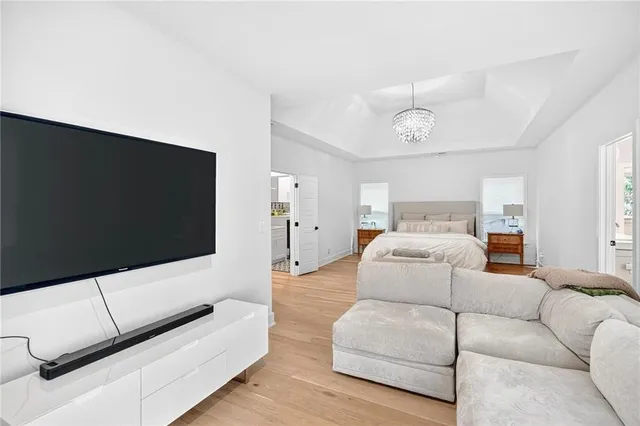 a large white bathroom with a granite countertop sink mirror and a bathtub