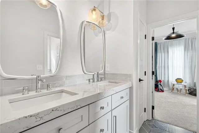 a bathroom with a toilet a sink and mirror