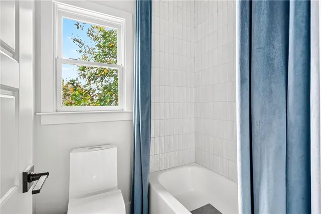 a view of a house with a yard and pathway