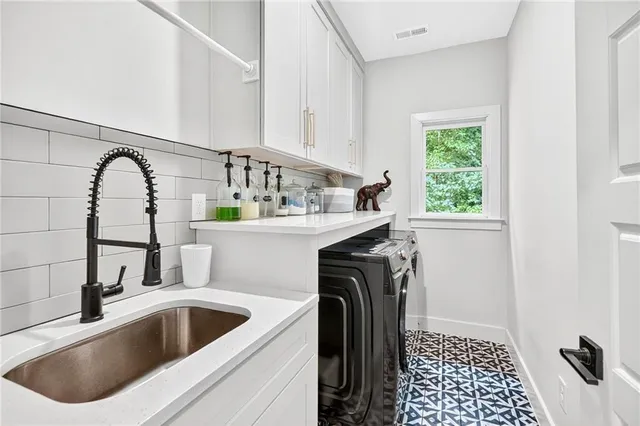 a view of a chairs and table in the backyard