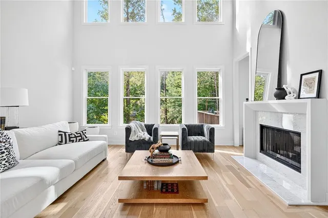 a living room with furniture fireplace and window