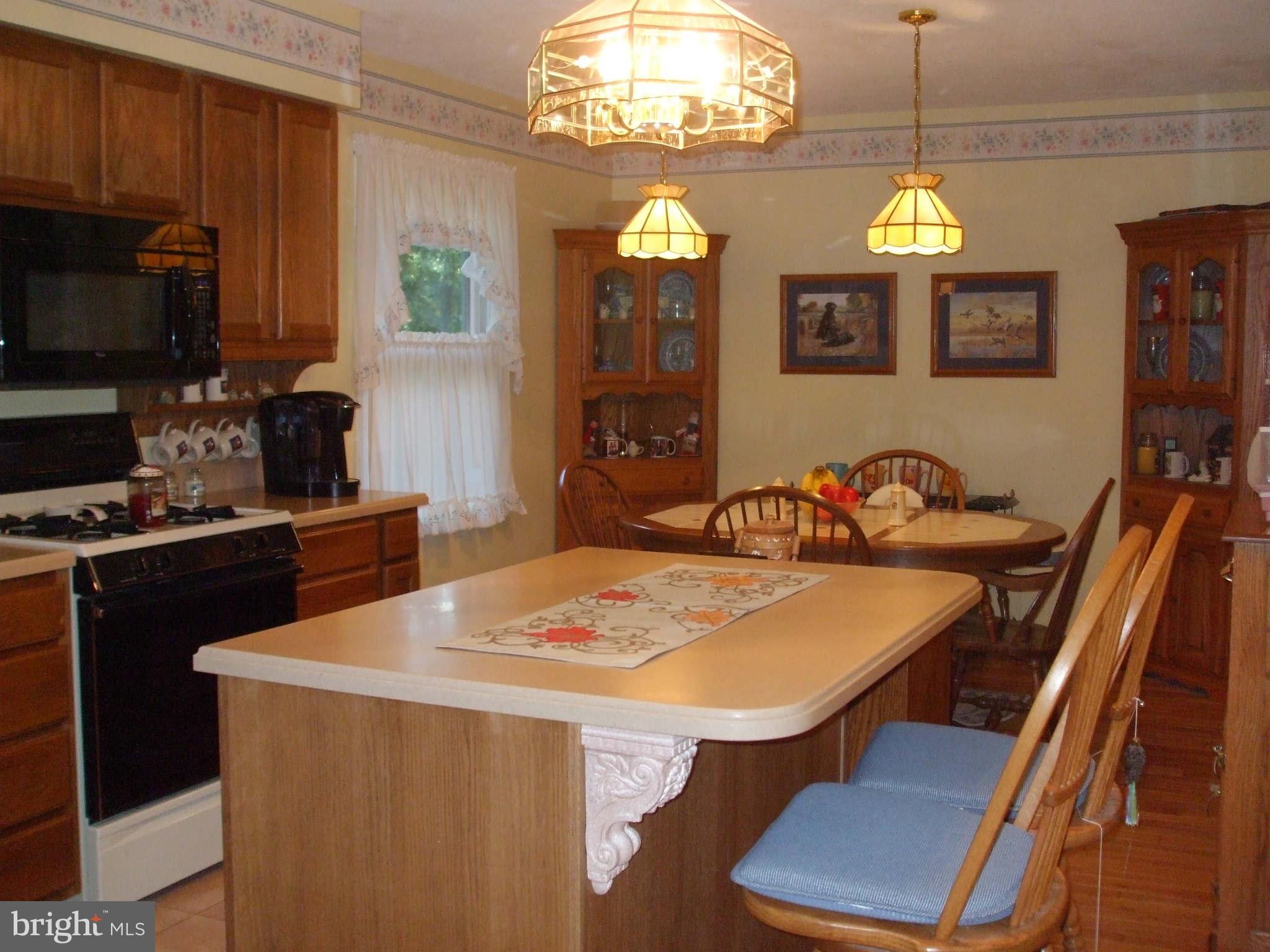 595 Ridgewood Road Bel Air, MD 21014 - Photo 12 of 26 a kitchen with a dining table and chairs