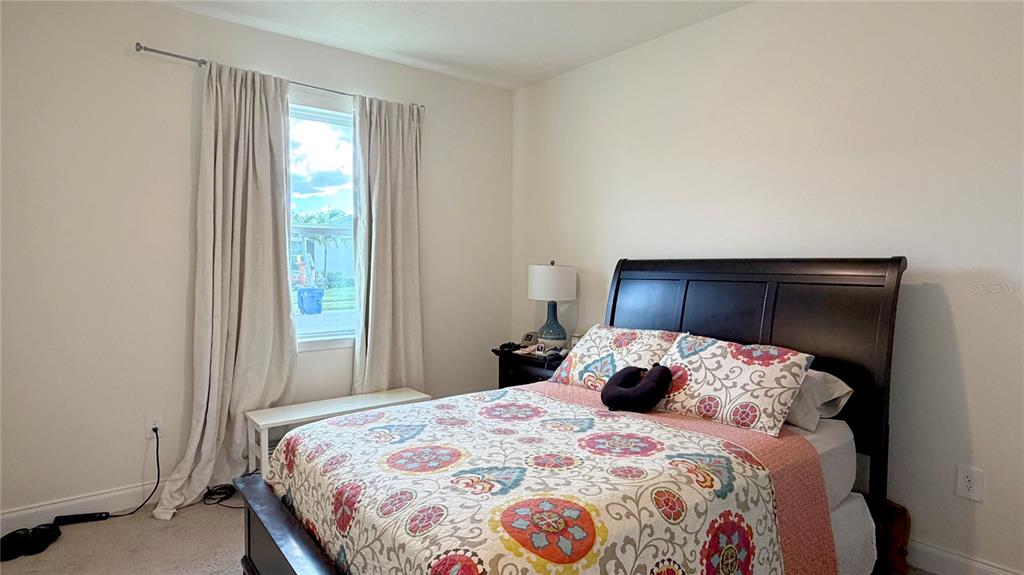 727 Annabell Rdg Road Minneola, FL 34715 - Photo 12 of 56 a bedroom with a bed and a window