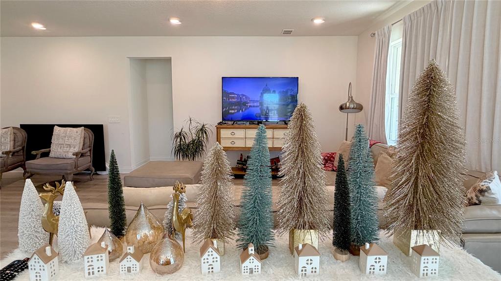 727 Annabell Rdg Road Minneola, FL 34715 - Photo 30 of 56 a living room with furniture and a flat screen tv