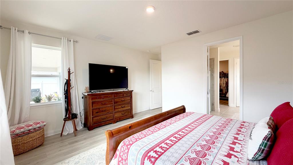 727 Annabell Rdg Road Minneola, FL 34715 - Photo 35 of 56 a bedroom with a bed and a flat screen tv