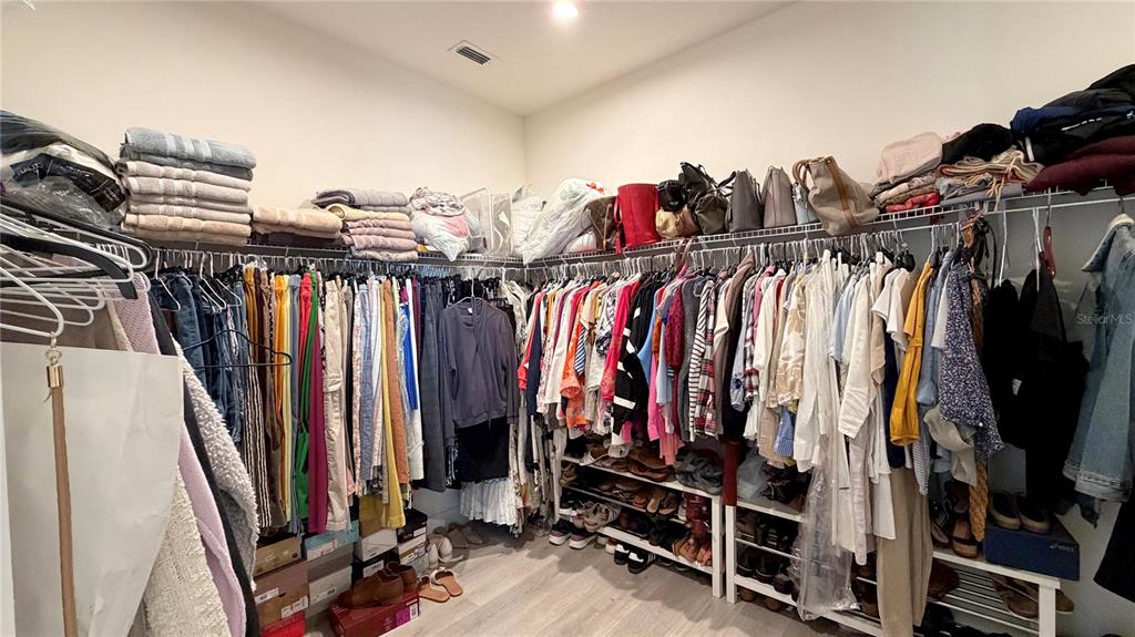 727 Annabell Rdg Road Minneola, FL 34715 - Photo 38 of 56 a view of walk in closet with clothes and shoes