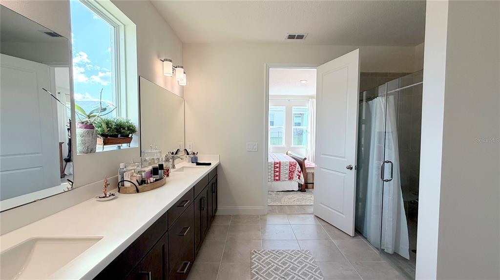 727 Annabell Rdg Road Minneola, FL 34715 - Photo 39 of 56 a bathroom with a double vanity sink and mirror