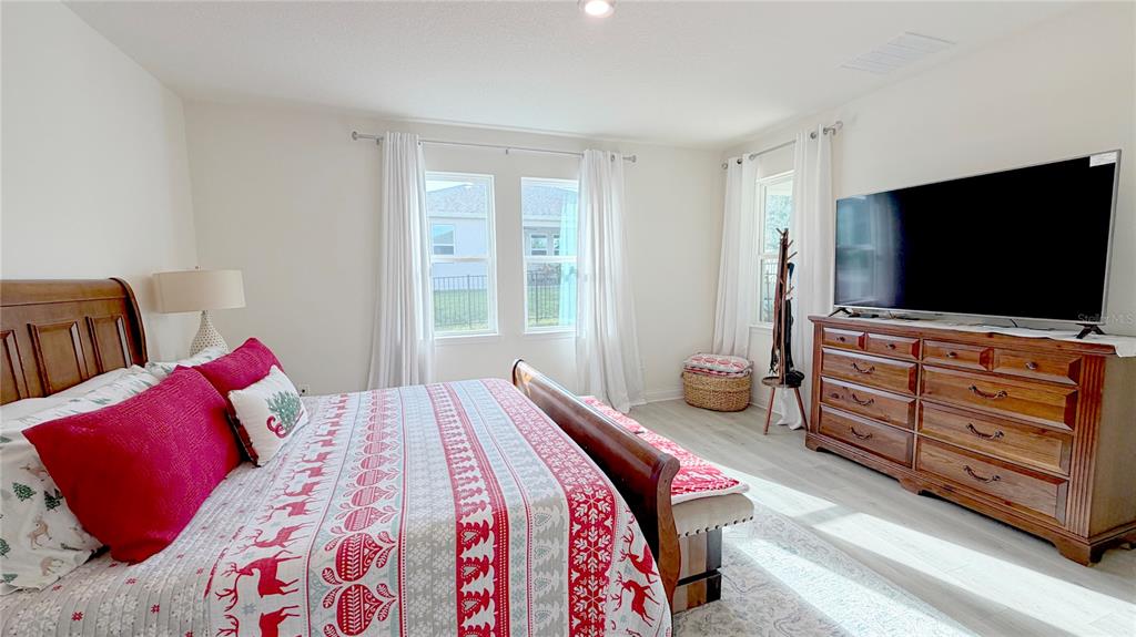 727 Annabell Rdg Road Minneola, FL 34715 - Photo 40 of 56 a bedroom with a bed and flat screen tv