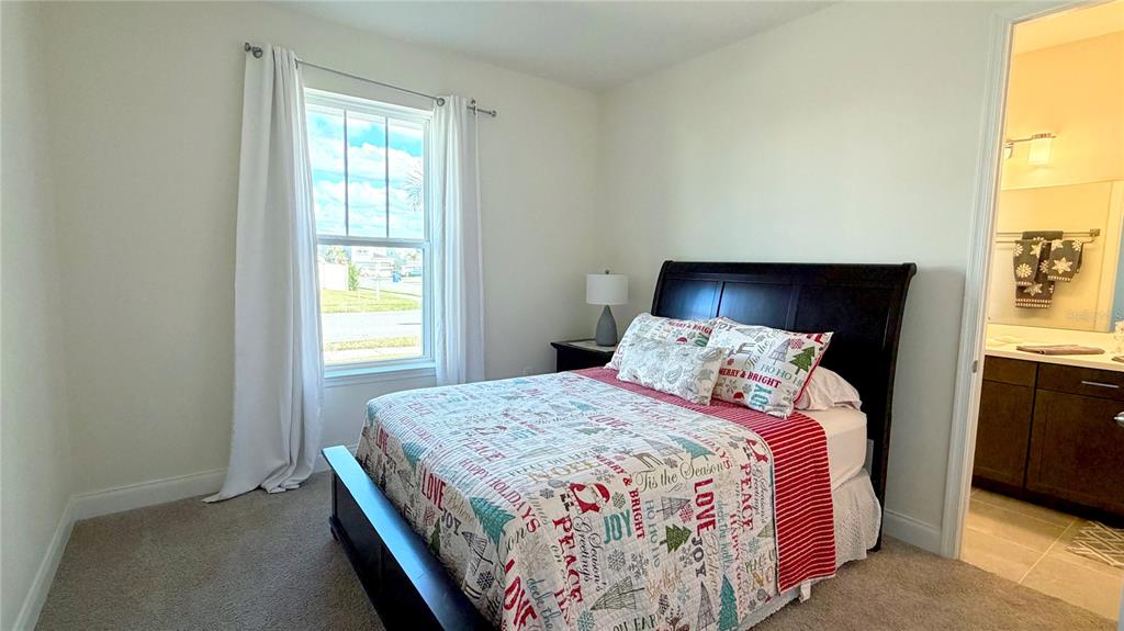 727 Annabell Rdg Road Minneola, FL 34715 - Photo 7 of 56 a bedroom with a bed and a window