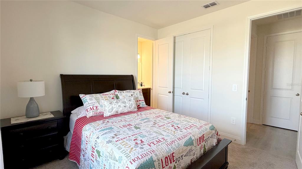 727 Annabell Rdg Road Minneola, FL 34715 - Photo 8 of 56 a bedroom with a bed and a lamp