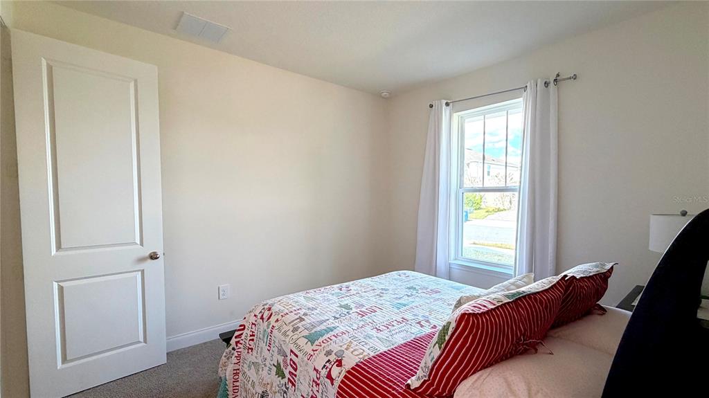 727 Annabell Rdg Road Minneola, FL 34715 - Photo 9 of 56 a bedroom with a bed and a window