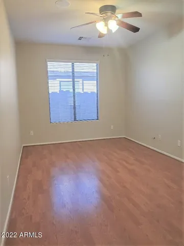 an empty room with windows and closet