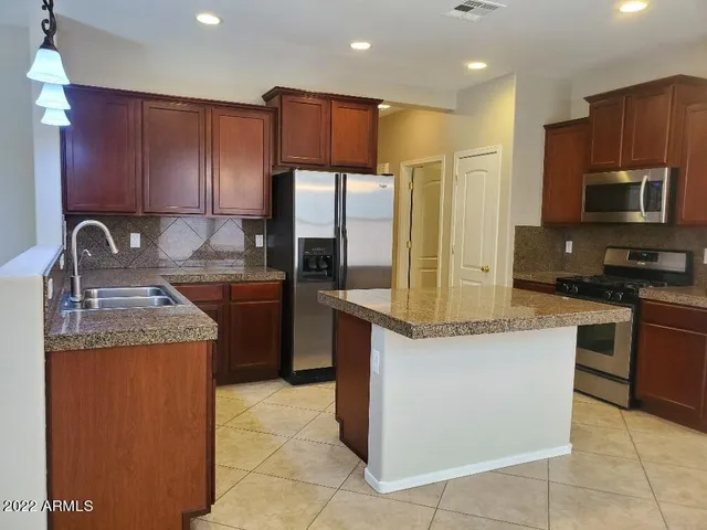 a kitchen with a center island and cabinets