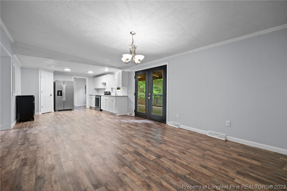 287 Doyle Cox Road Sanford, NC 27330 - Photo 11 of 35 a view of a livingroom with a chandelier