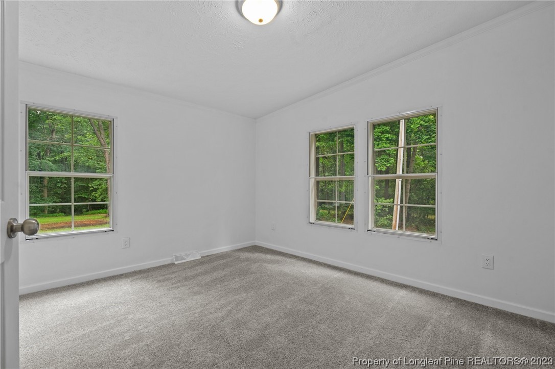 287 Doyle Cox Road Sanford, NC 27330 - Photo 12 of 35 an empty room with a window