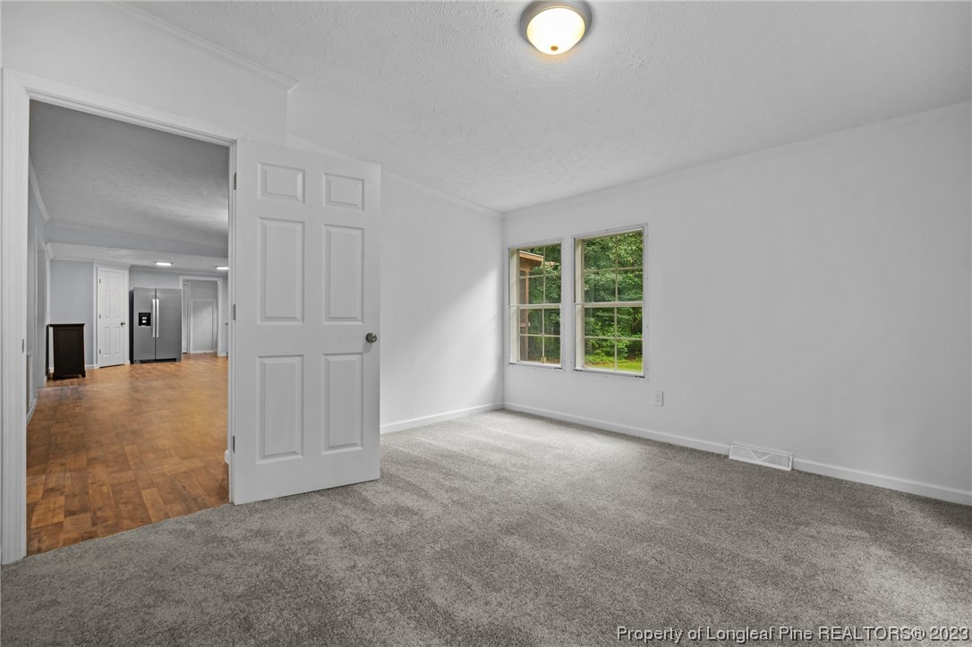 287 Doyle Cox Road Sanford, NC 27330 - Photo 13 of 35 an empty room with windows