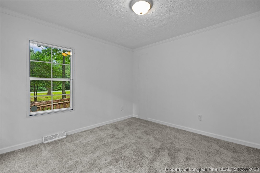 287 Doyle Cox Road Sanford, NC 27330 - Photo 15 of 35 an empty room with a window
