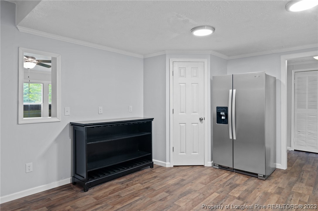 287 Doyle Cox Road Sanford, NC 27330 - Photo 21 of 35 a view of an empty room with wooden floor and a window