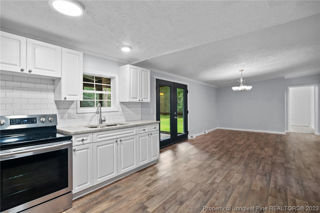287 Doyle Cox Road Sanford, NC 27330 - Photo 22 of 35 a kitchen with stainless steel appliances granite countertop a stove a sink and a refrigerator