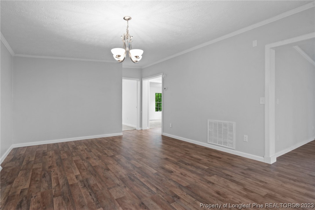 287 Doyle Cox Road Sanford, NC 27330 - Photo 25 of 35 an empty room with wooden floor and windows
