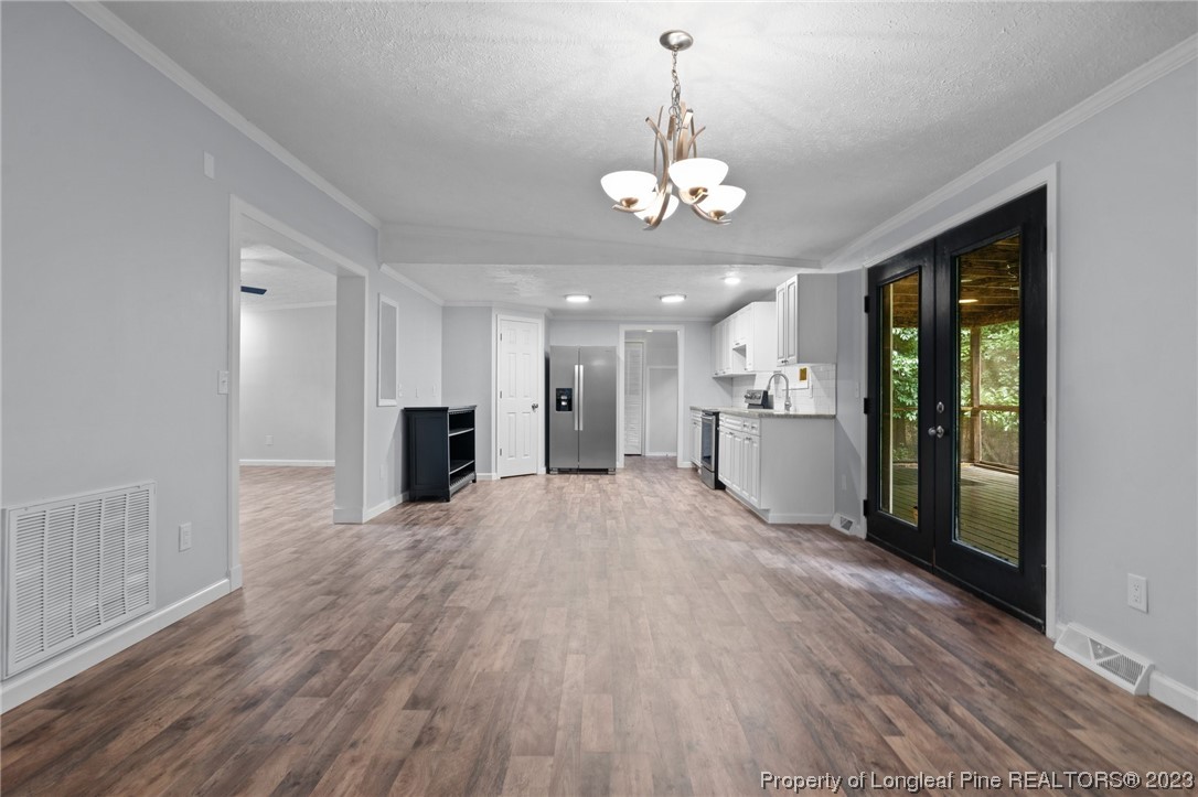 287 Doyle Cox Road Sanford, NC 27330 - Photo 26 of 35 a view of a kitchen with a sink and dishwasher a refrigerator with wooden floor