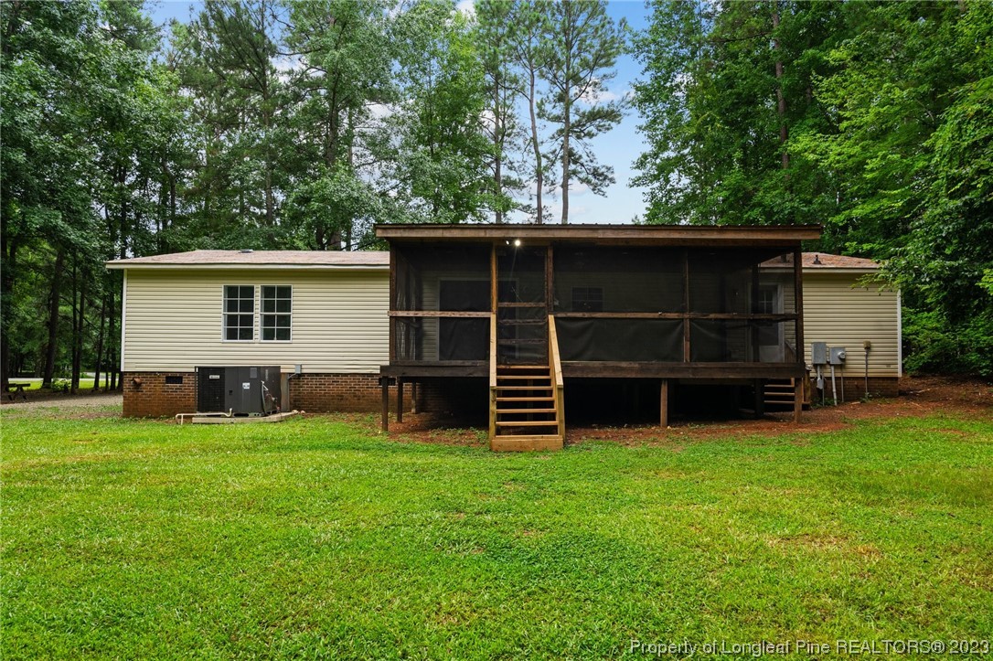 287 Doyle Cox Road Sanford, NC 27330 - Photo 29 of 35 a view of a house with a yard and a large tree