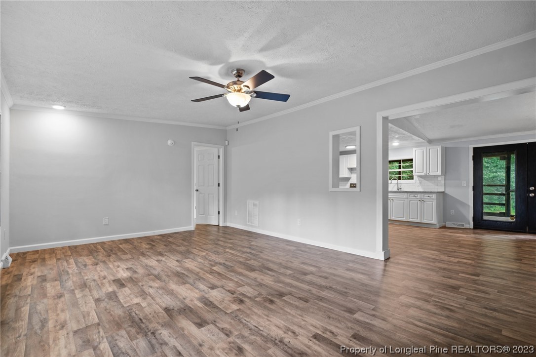287 Doyle Cox Road Sanford, NC 27330 - Photo 3 of 35 a view of an empty room with window and wooden floor