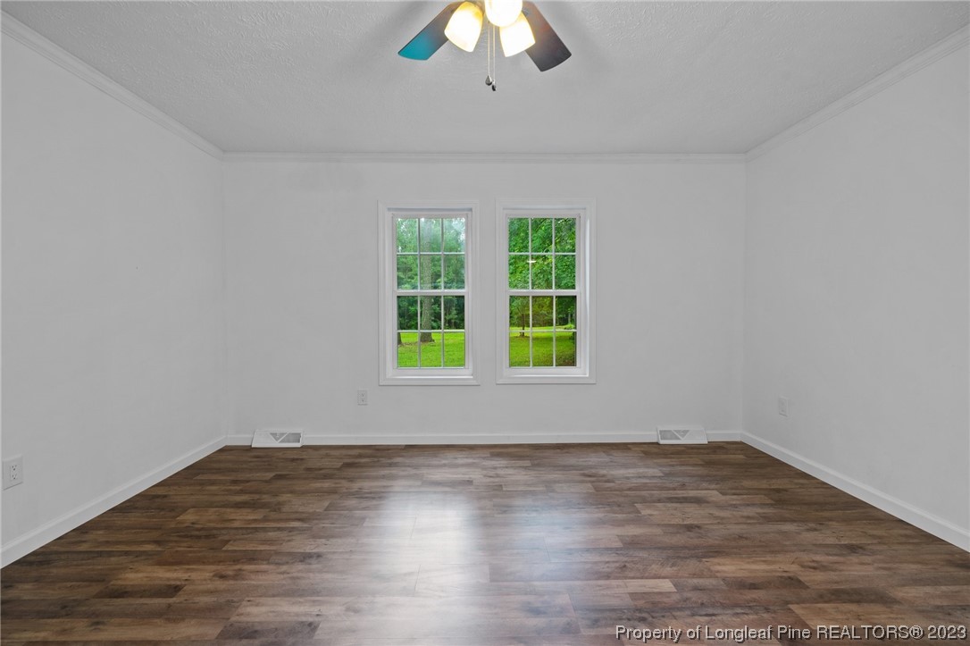 287 Doyle Cox Road Sanford, NC 27330 - Photo 7 of 35 wooden floor in an empty room with a window